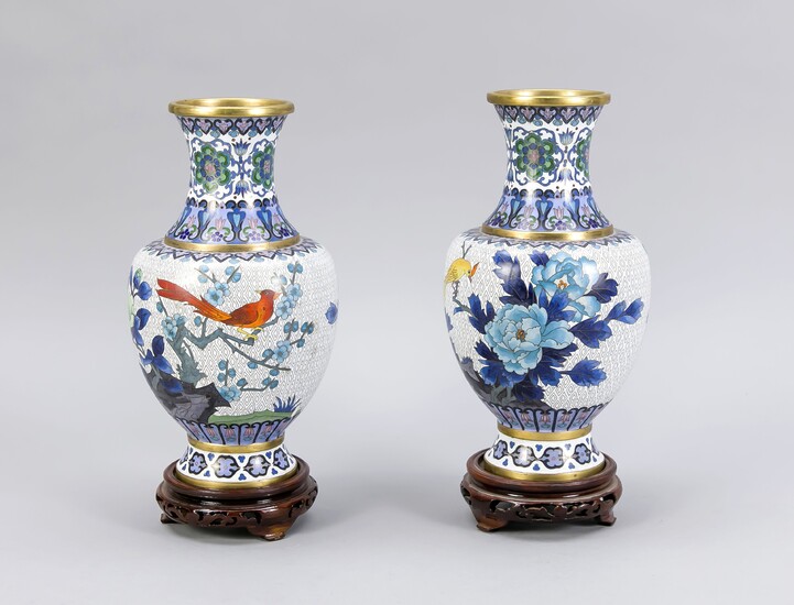 Pair of cloisonné vases, China, 20th cent. Decoration with birds between flowers and twigs against a white background, set off by borders. Neck with appropriate decoration. On a round, open worked wooden bases, h. without base 26 cm