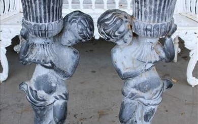 Pair of gray cast iron garden planters with figure base