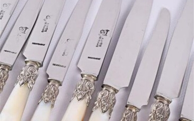 Set of twelve table knives and twelve dessert knives, mother-of-pearl handles, silver ferrules decorated with acanthus leaves and garlands of scalloped bay leaves, stainless steel blades.