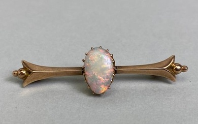 Unmarked antique gold bar brooch set with a pear shaped opal...