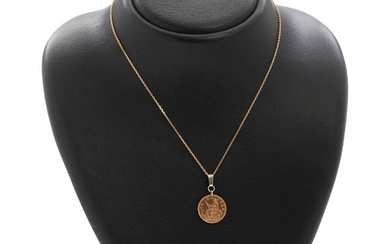 Pendant set with a 21k gold coin, mounted in 14k gold. An 8k gold necklace included. Pendant L. 3. Necklace L. 24 cm.