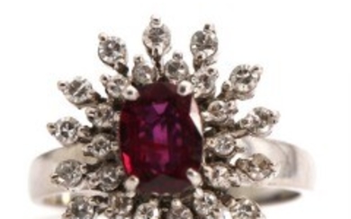 1918/1162 - Ruby and diamond ring set with faceted ruby encircled by numerous single-cut diamonds, mounted in 14k white gold. Size 58. Weight app. 6 g.