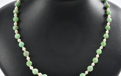 A STRAND OF JADEITE BEADS AND PEARLS, THE CLASP IN 9CT GOLD
