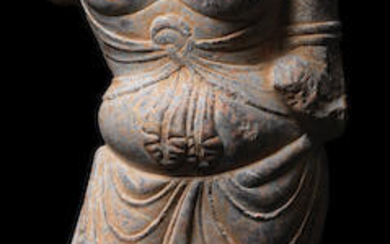 A grey limestone stone torso of a bodhisattva