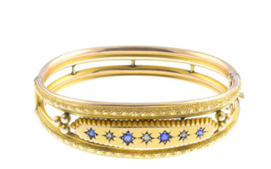 An Edwardian 9ct gold diamond and blue gem hinged bangle.