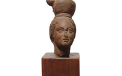 Egyptian terracotta head of a woman with ewer