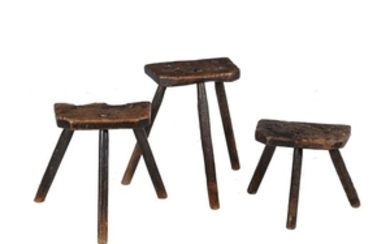 Three rough hewn oak stools, possibly milking stools, 17th century