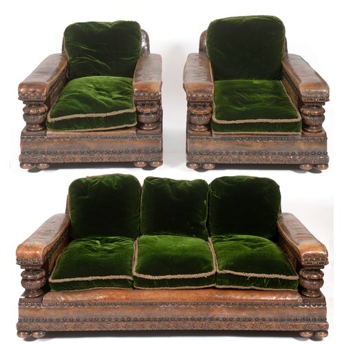 A 1920s leather and carved oak country house three piece sui...