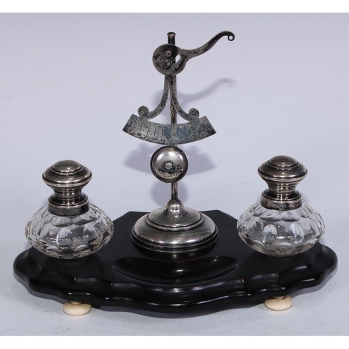 A 19th century Dutch silver and ebonised inkwell, central le...