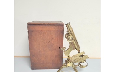 A 19th century monocular microscope by Dollond of London c18...