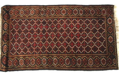 A 20th century wool rug woven with geometric patterns. With a continuous pattern of geometric shapes in red tones on a dark blue ground, within a similar pattern border, 110cm x 198cm