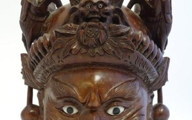 A 20thC Chinese carved hardwood mask with carved dragon
