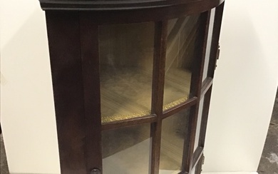 A C20th mahogany corner cabinet, the moulded cornice above a...