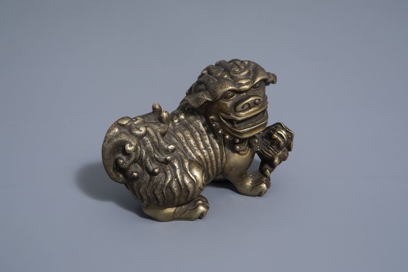 A Chinese bronze model of a Buddhist lion,...