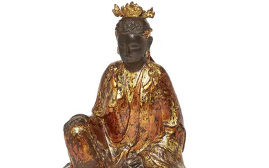 A Chinese lacquered bronze figure of Guanyin 17th/18th century Cast seated in...