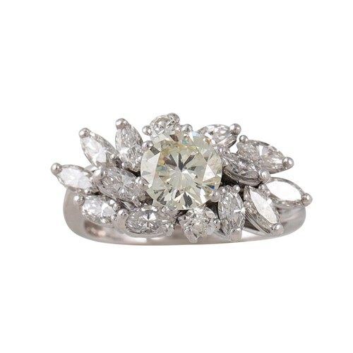 A DIAMOND CLUSTER RING, the brilliant cut diamond to a marqu...