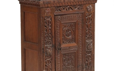 A Danish 18th century richly carved oak Regence cabinet, front with door. H. 96. W. 67. D. 37 cm.