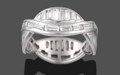 A Diamond Eternity Ring, two entwined rows of baguette cut...