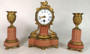 A FRENCH 19TH CENTURY CORAL MARBLE AND BRONZE ORMOLU CLOCK G...
