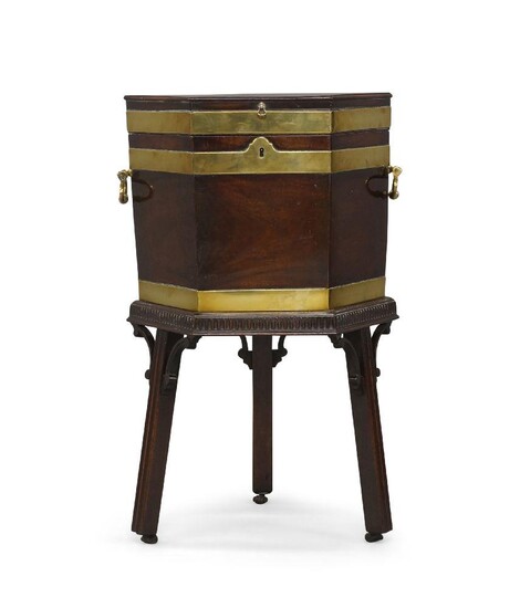 A George III mahogany and brass bound cellarette, raised on stand with moulded frieze and fret work, reeded supports and castors, 74cm high, 45cm wide, 40cm deep