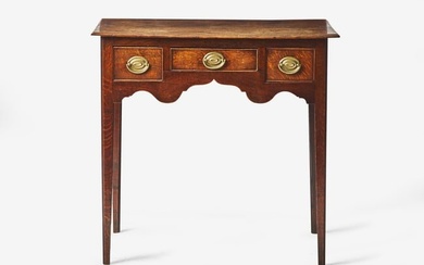 A George III provincial carved oak dressing table, late 18th century With rectangular top with