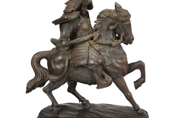 A Japanese carved wood mounted warrior sculpture
