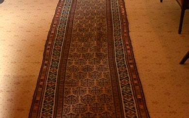 A LONG ANTIQUE PERSIAN RUNNER. 456 cm x 90 cm.
