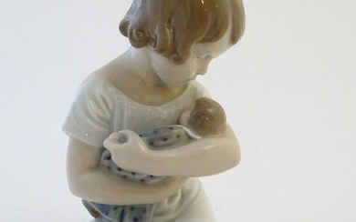 A Royal Copenhagen model of a seated girl with a doll