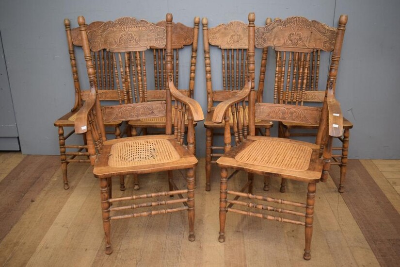 A SET OF SIX AMERICAN OAK SPINDLE BACK DINING CHAIRS, WITH WOVEN CANE SEATS, INCLUDING TWO CARVERS (CANE SEAT A/F TO ONE CARVER) (11...