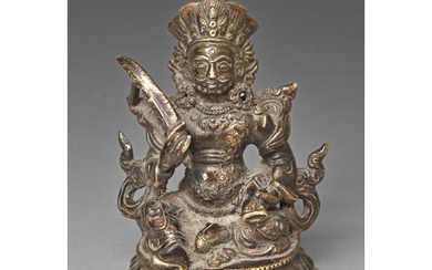 A Sino-Tibetan bronze sculpture of a guardian, on lotus base...