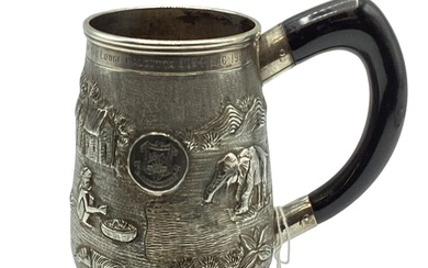 A South Asian white metal mug with country scenes...