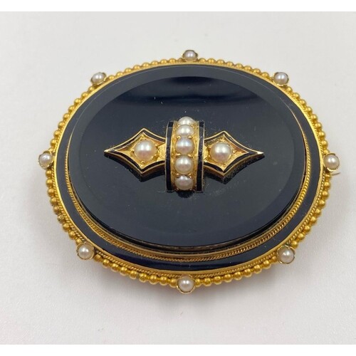A Victorian yellow gold brooch with black enamel and seed pe...
