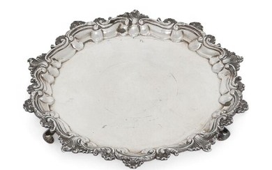 A William IV silver salver, London, c.1830, J. E. Terrey, of shaped circular form with plain base and applied scroll and shell rim, the salver raised on three scroll feet, 25cm dia., approx. weight 15.6oz