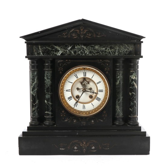 A black marble mantel clock in the shape of a temple. Early 20th century. H. 46,5 cm. W. 45 cm. D. 17 cm.
