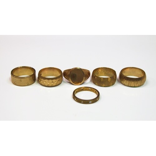 A collection of six 9ct gold rings, to include four thick fa...