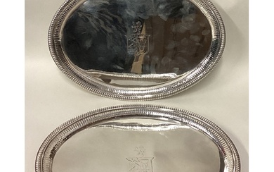 A fine and rare pair of George III silver salvers with gadro...