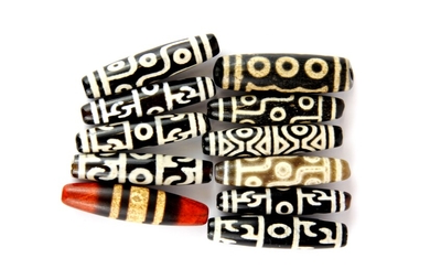 A group of 11 Tibetan Dzi beads, longest L. 6cm.