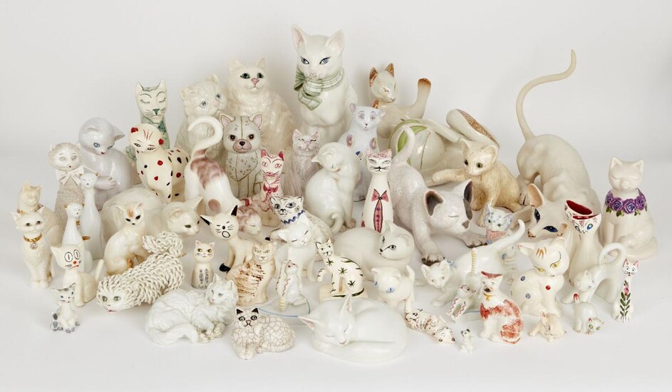 A group of pottery cats with overall cream and white colour way of varying designs and makers to include; a seated cat by Beswick, 22.5cm, a Galos recumbent cat with iridescent glaze, printed with hand-painted marks to base, a Meissen cat with blue...