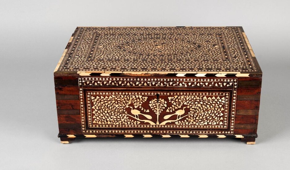 A large Horshiapur ivory inlaid chest, India, 19th century, of rectangular form, with hinged lid, inlaid with design of ovoid medallion to lid with two surrounding rectangular cartouches in ebony and ivory chevrons, on a dense ground of leaves, the...