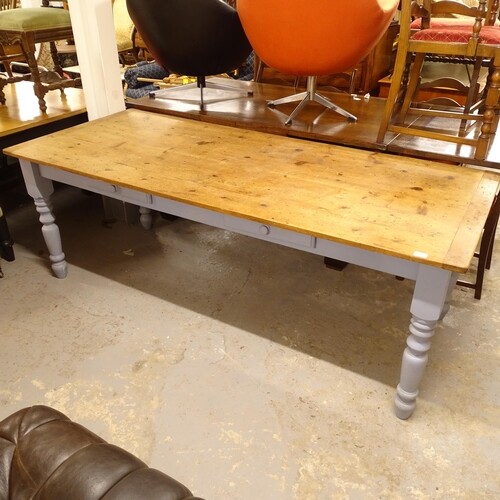 A large polished and painted pine kitchen dining table, with...