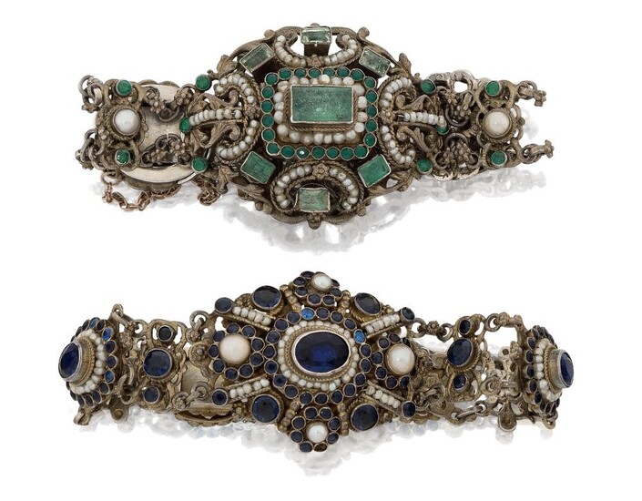 A late 19th century Austro-Hungarian emerald and seed pearl silver gilt bracelet, with three panels of closed-set emeralds, seed pearls and green paste connected by flowerhead mounted cable links and openwork panel spacers, together with a similar...