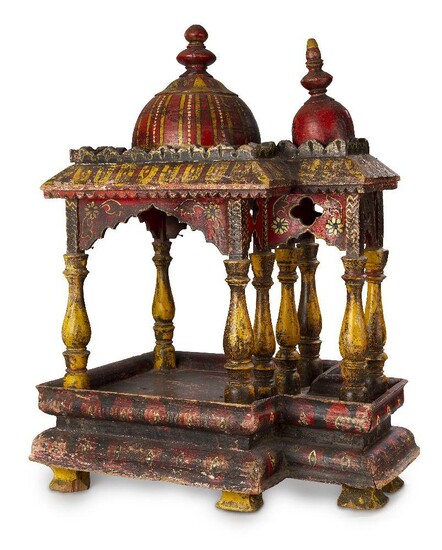 A painted and gilded wooden model of a howdah, India, 19th century, on bracket feet, the rectangular superstructure with chaitya-form archways and surmounted by crenelated band enclosing a tall faceted wood dome, painted in red, yellow and white...