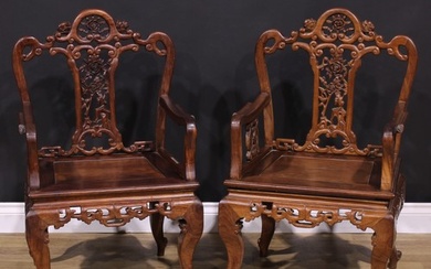A pair of Chinese hardwood armchairs, each with a shaped bac...