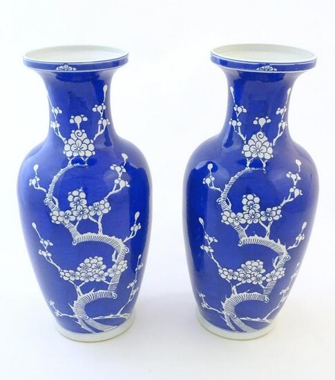 A pair of Oriental vases with a blue glaze decorated