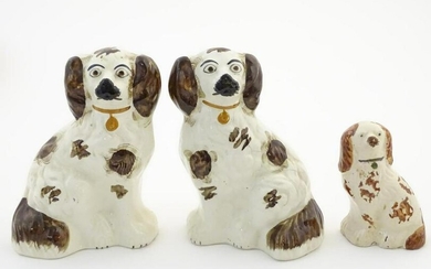 A pair of Staffordshire pottery seated spaniels