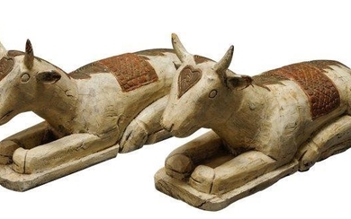 A pair of carved wood recumbent oxen,...