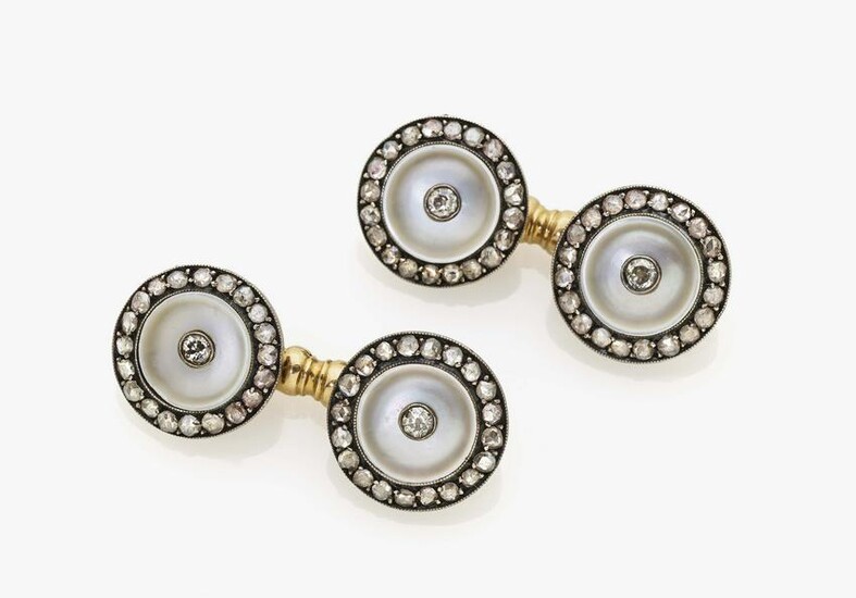 A pair of cufflinks with diamonds and mother-of-pearl