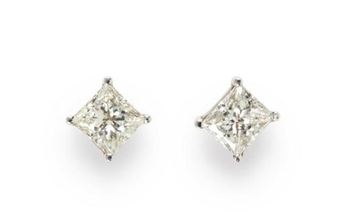 A pair of diamond and fourteen karat white gold stud