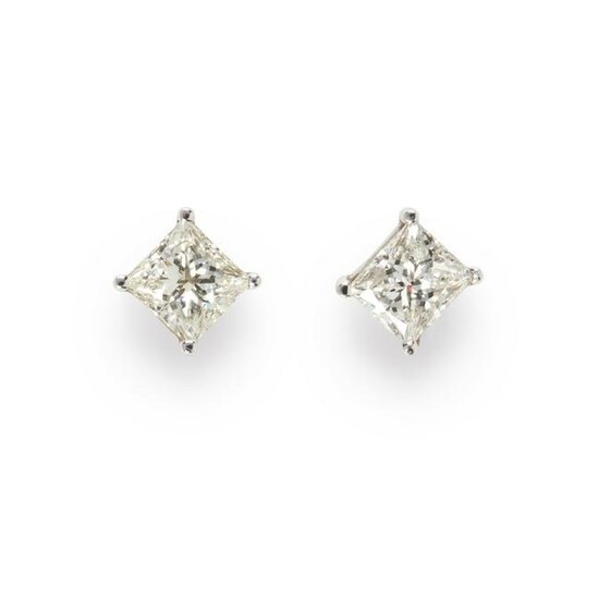 A pair of diamond and fourteen karat white gold stud