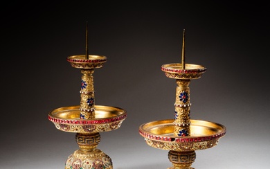 A pair of gilt-bronze and coloured pastes embellished candlesticks, Qing dynasty, Qianlong period | 清乾隆 鎏金銅嵌寳燭臺一對